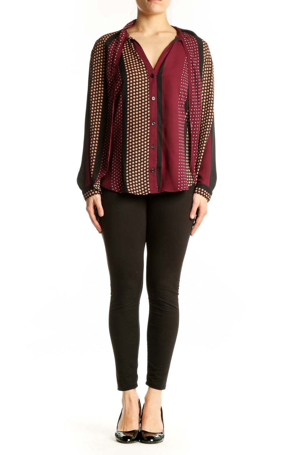 Burgundy polka dot button-up blouse with cream and gold patterned sleeves, front view on model
