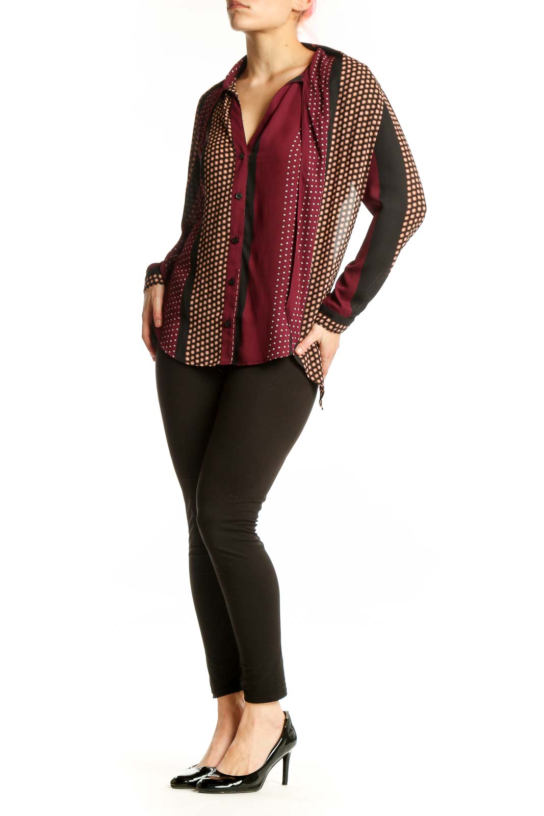 Burgundy polka dot button-up blouse with cream and gold patterned sleeves, front view on model