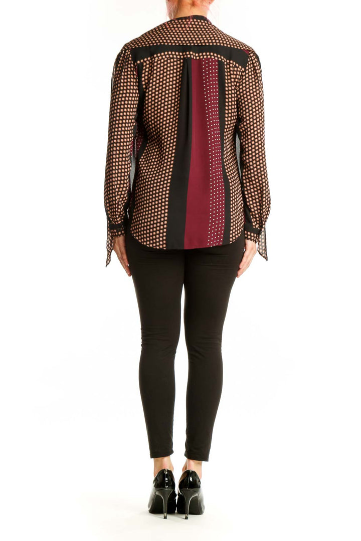Burgundy polka dot button-up blouse with cream patterned detailing, back view on model wearing black pants
