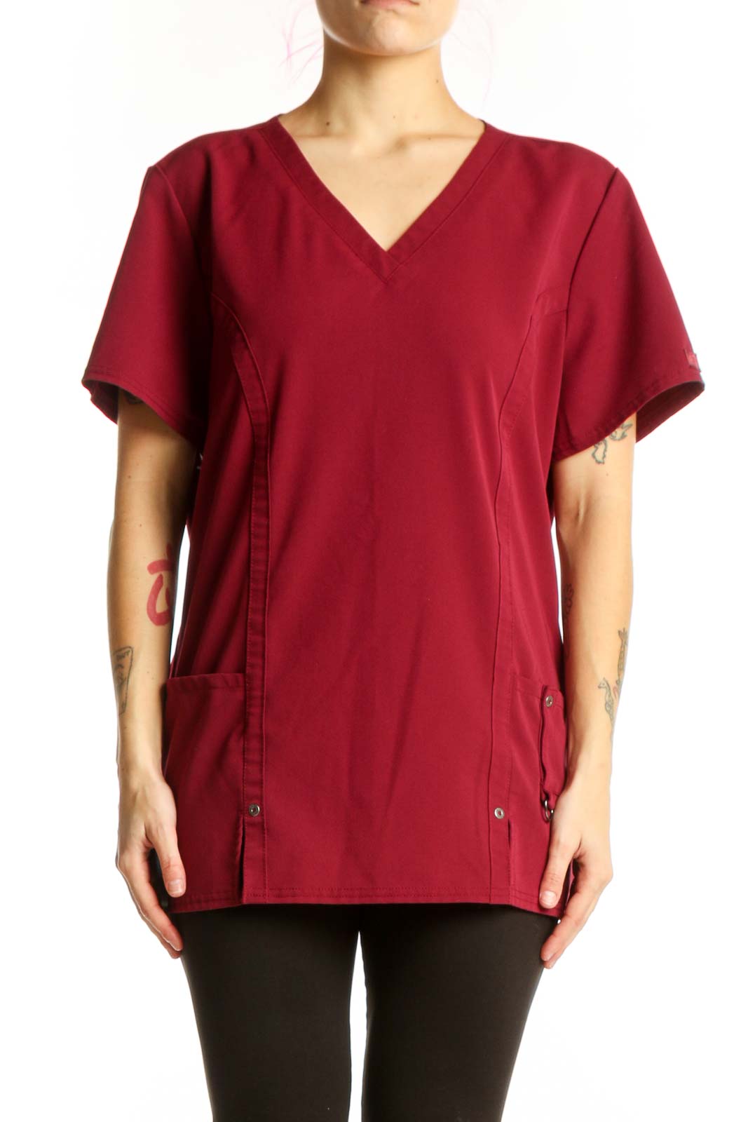 Burgundy v-neck short sleeve top with side pockets and button details, front view on model