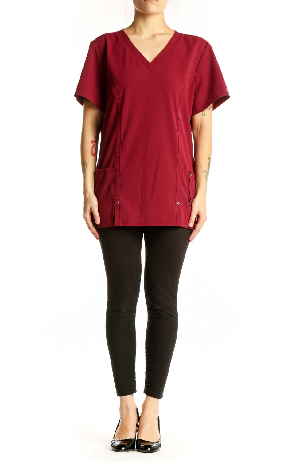 Burgundy v-neck short sleeve top with side pockets and button details, front view on model