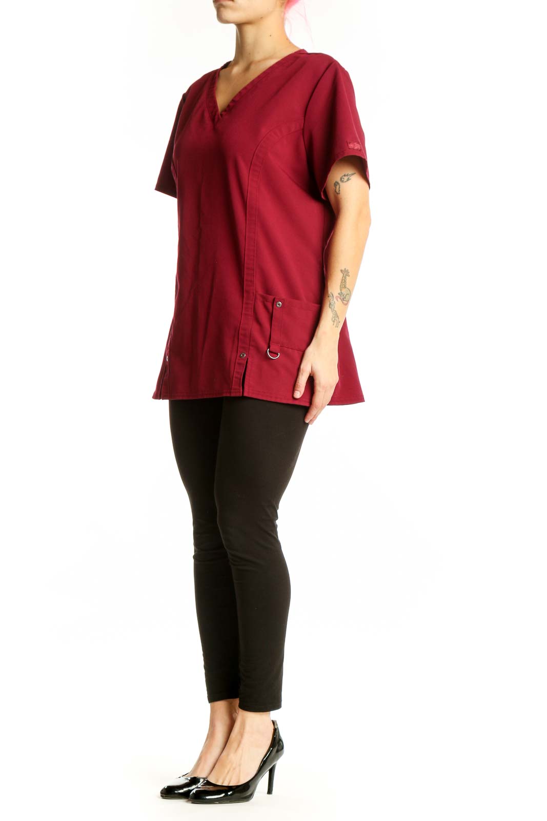 Burgundy v-neck short sleeve top with side pockets and button details, front view on model