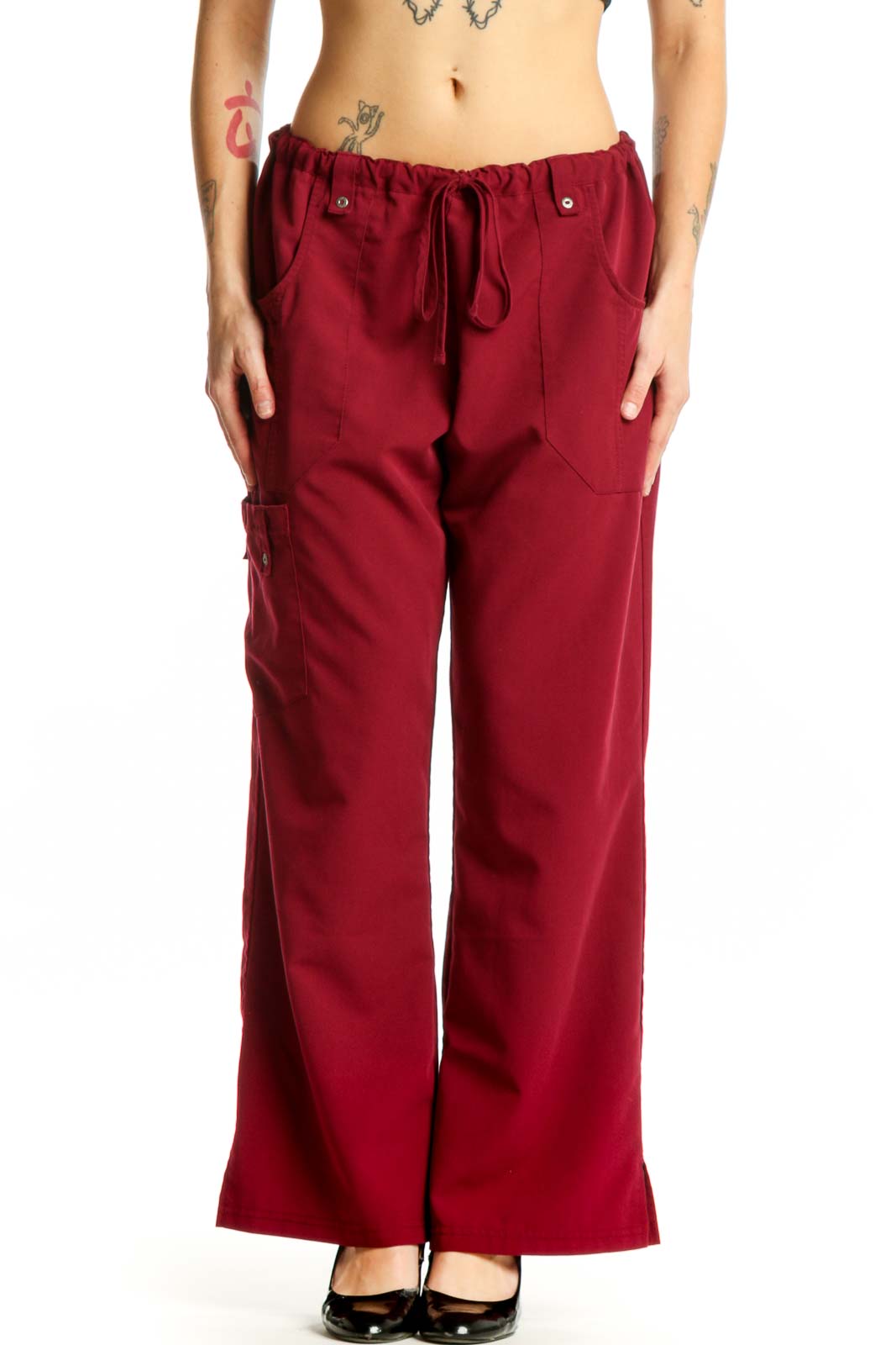 Front view of burgundy Dickies cargo pants with drawstring waist and functional side pockets on model