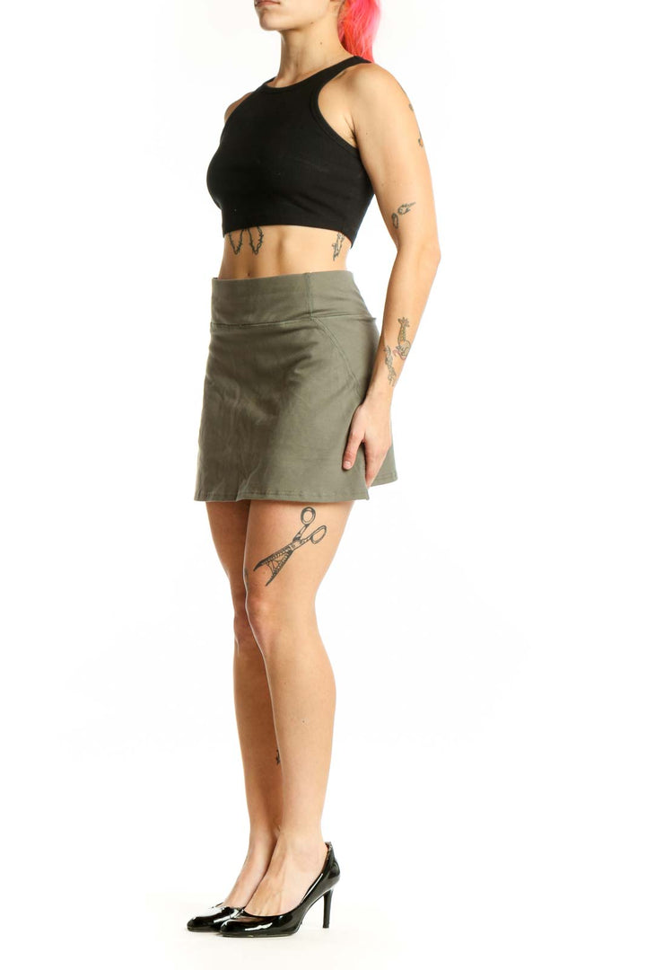 Sage green mini A-line skirt with high waist, front view on model