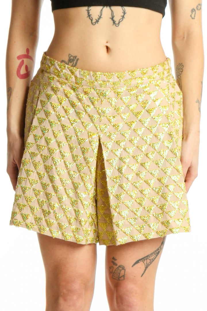 Front view of yellow floral print cotton shorts with A-line silhouette and front pleat detail