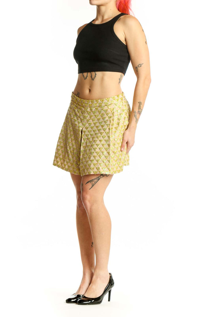 Front view of yellow floral print cotton shorts with A-line silhouette and front pleat detail