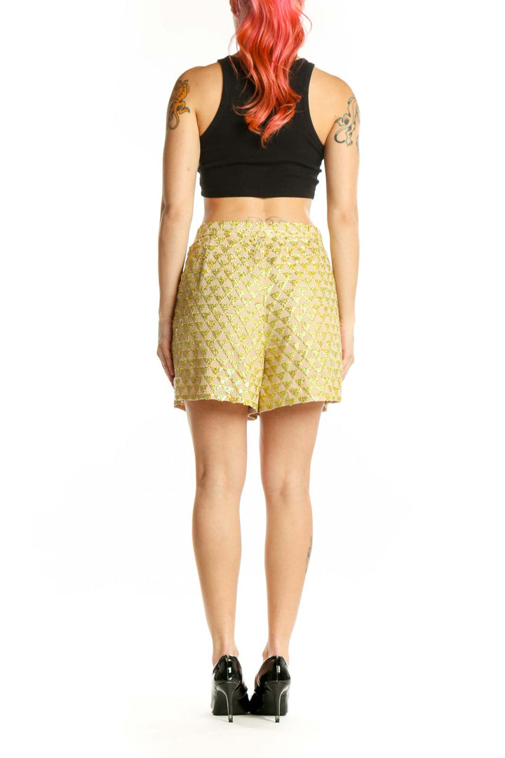 Back view of yellow floral print cotton shorts showing relaxed fit and knee-length cut