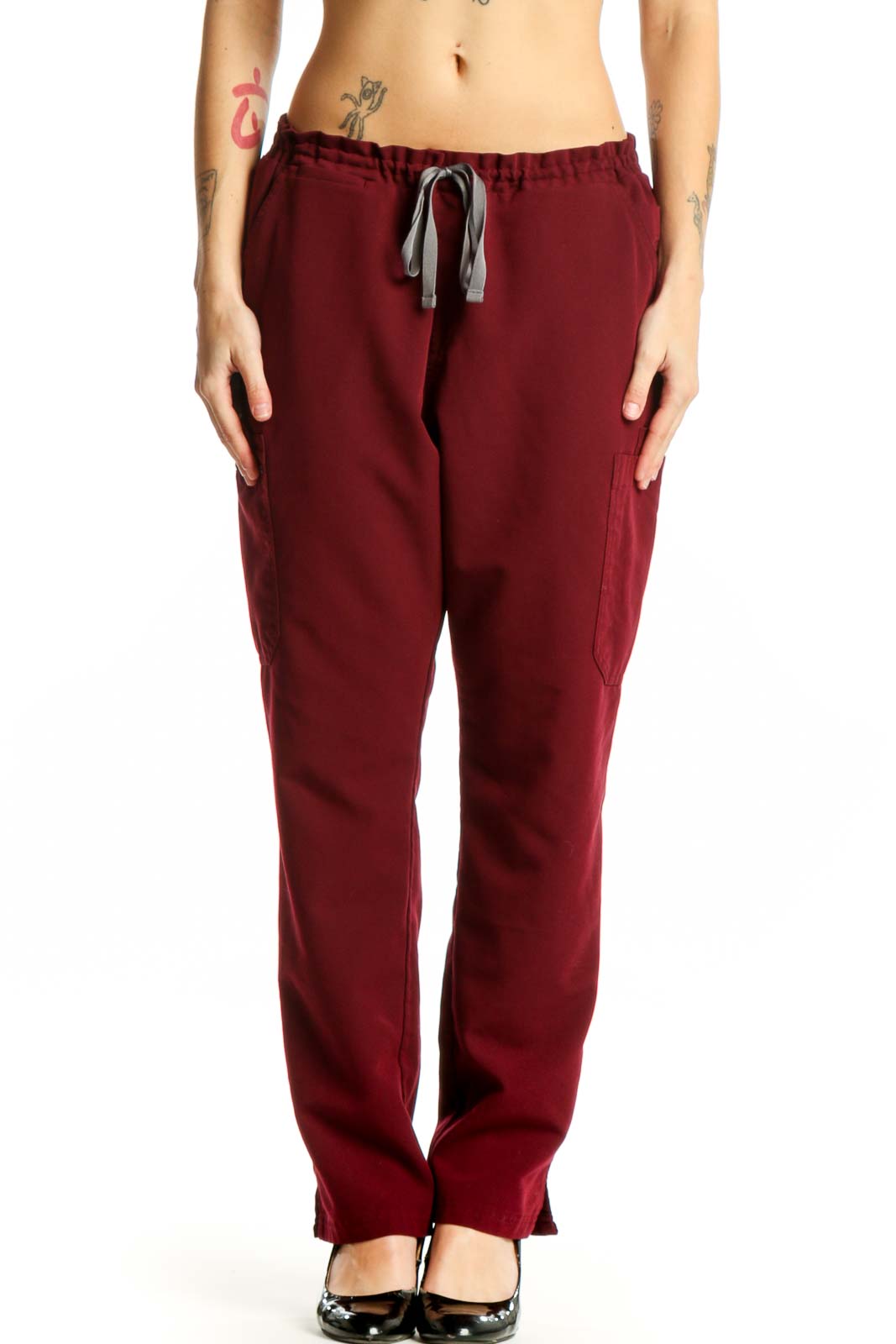 Front view of burgundy drawstring cargo pants with side pockets and elastic waistband