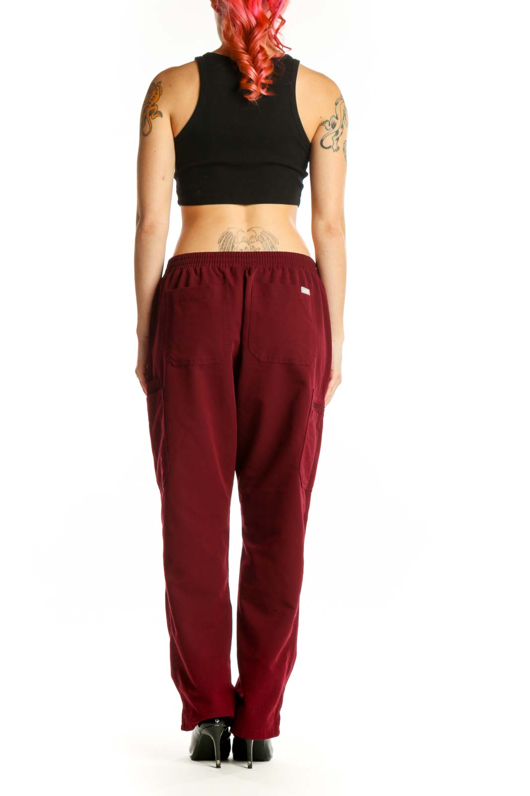 Back view of burgundy cargo pants showing functional side cargo pockets and relaxed fit silhouette