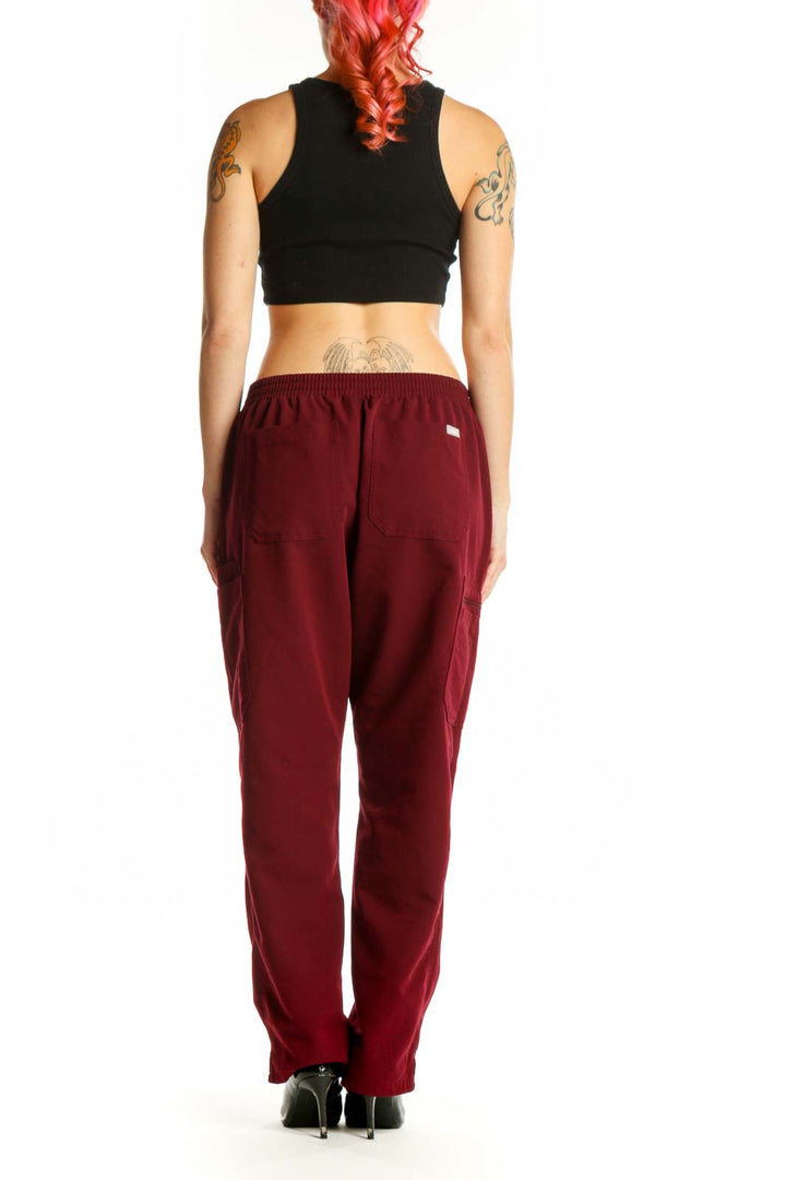 Back view of burgundy cargo pants showing functional side cargo pockets and relaxed fit silhouette
