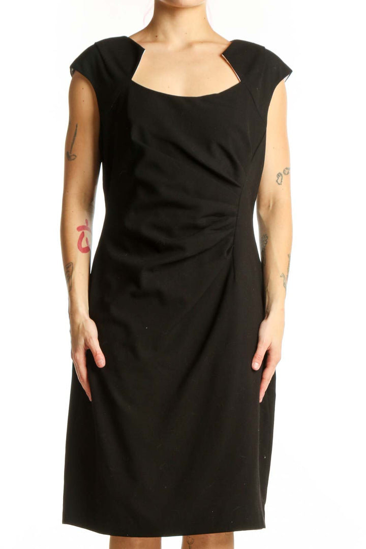 Black ruched cap sleeve dress with scoop neckline, front view on model