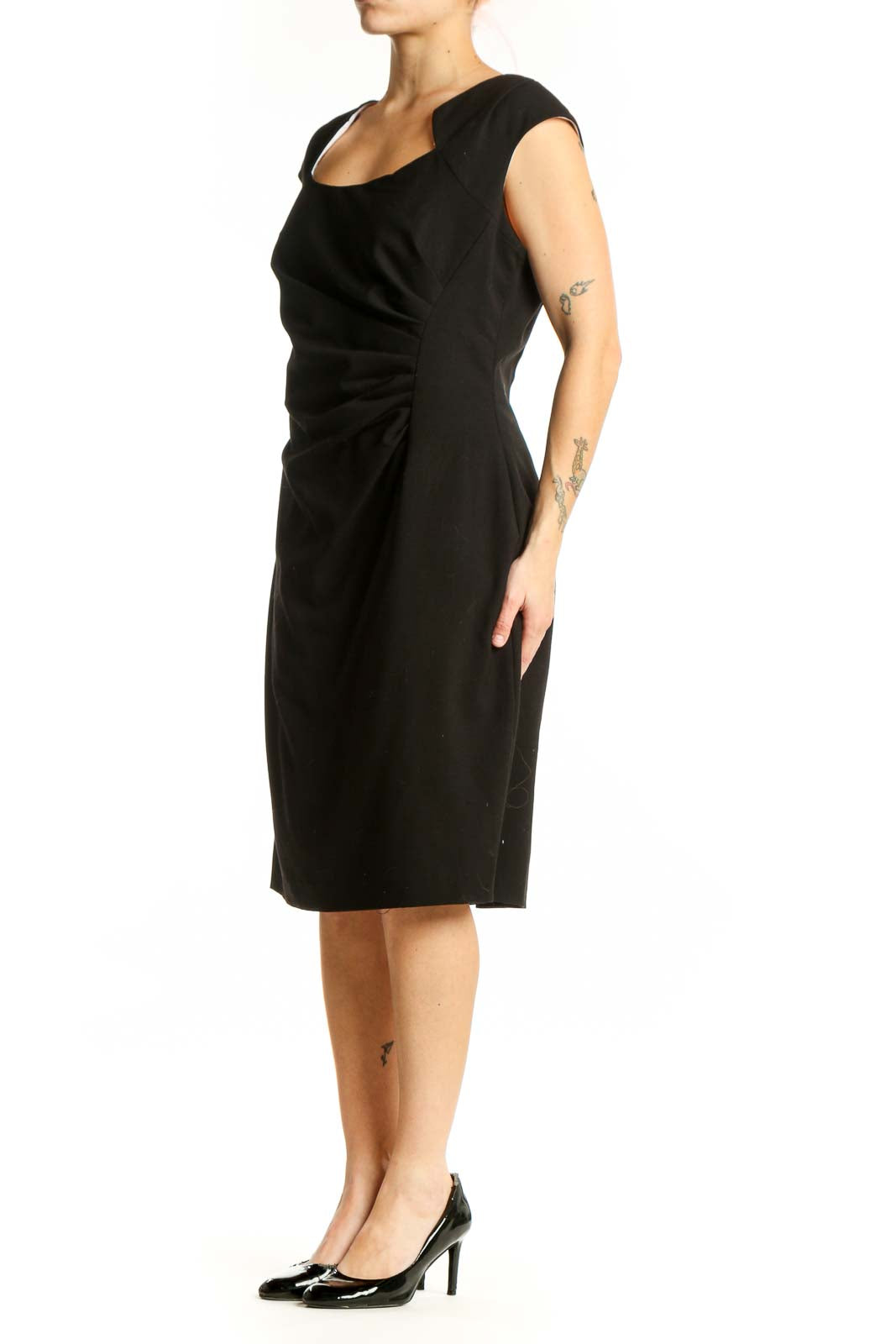 Black ruched cap sleeve dress with scoop neckline, front view on model