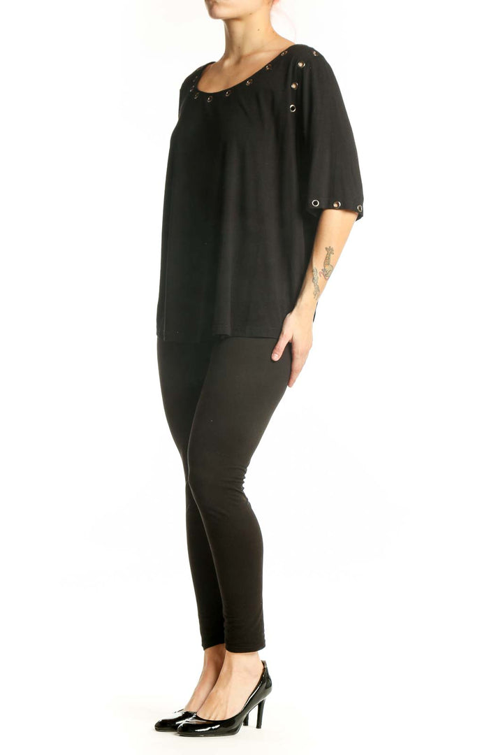 Black studded half sleeve top with metal studs on neckline and cuffs, front view on model