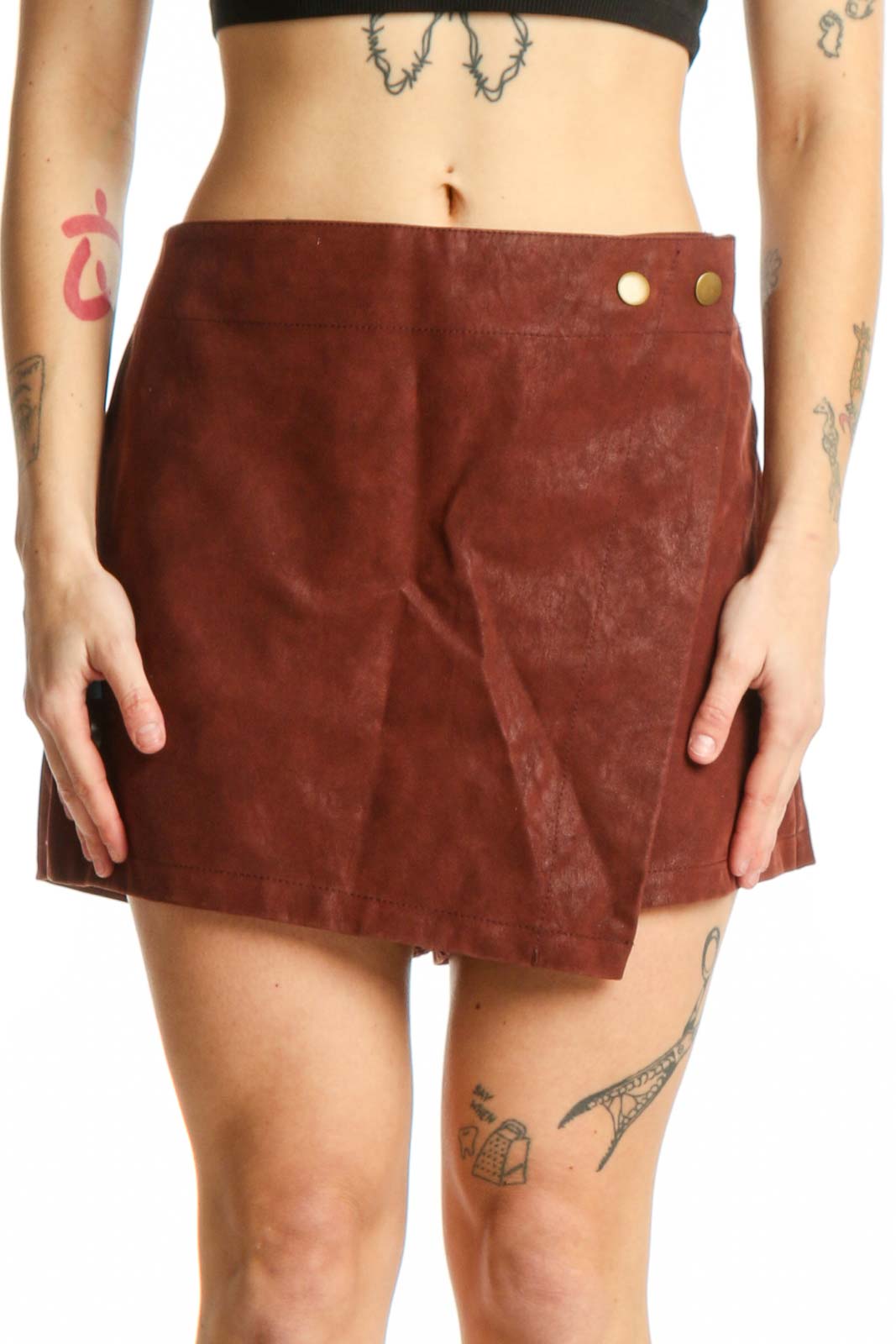 Burgundy suede mini shorts with metallic button accents and asymmetrical A-line hem, front view