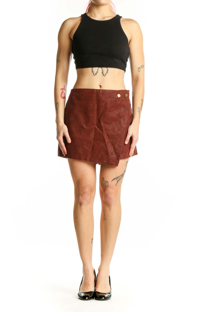Burgundy suede mini shorts with metallic button accents and asymmetrical A-line hem, front view