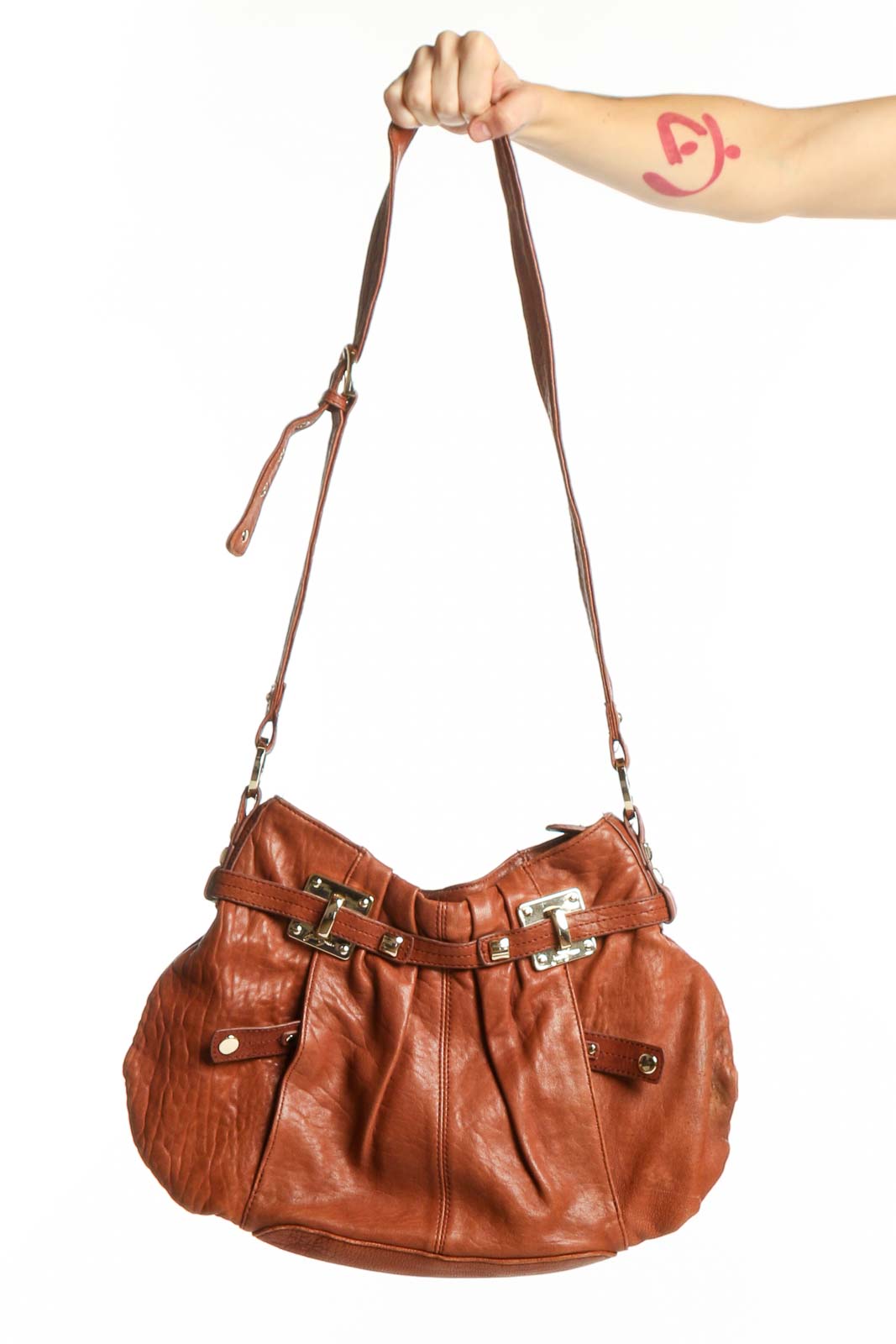 Cognac leather shoulder bag with polished hardware buckle details and adjustable leather straps
