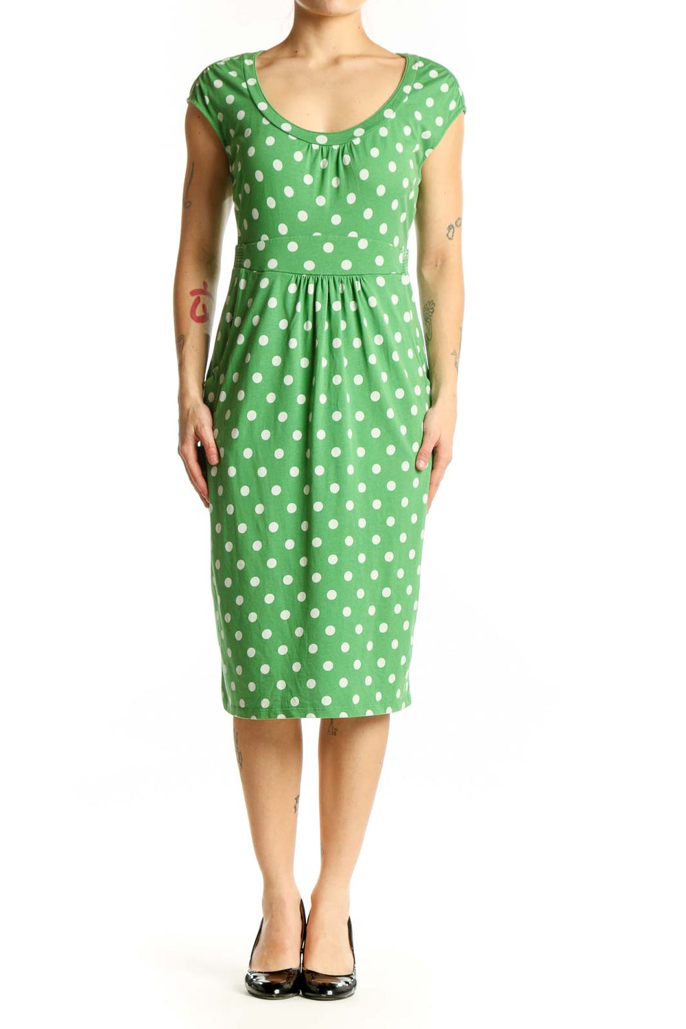 Green polka dot midi dress with white dots, scoop neckline, and cap sleeves on model