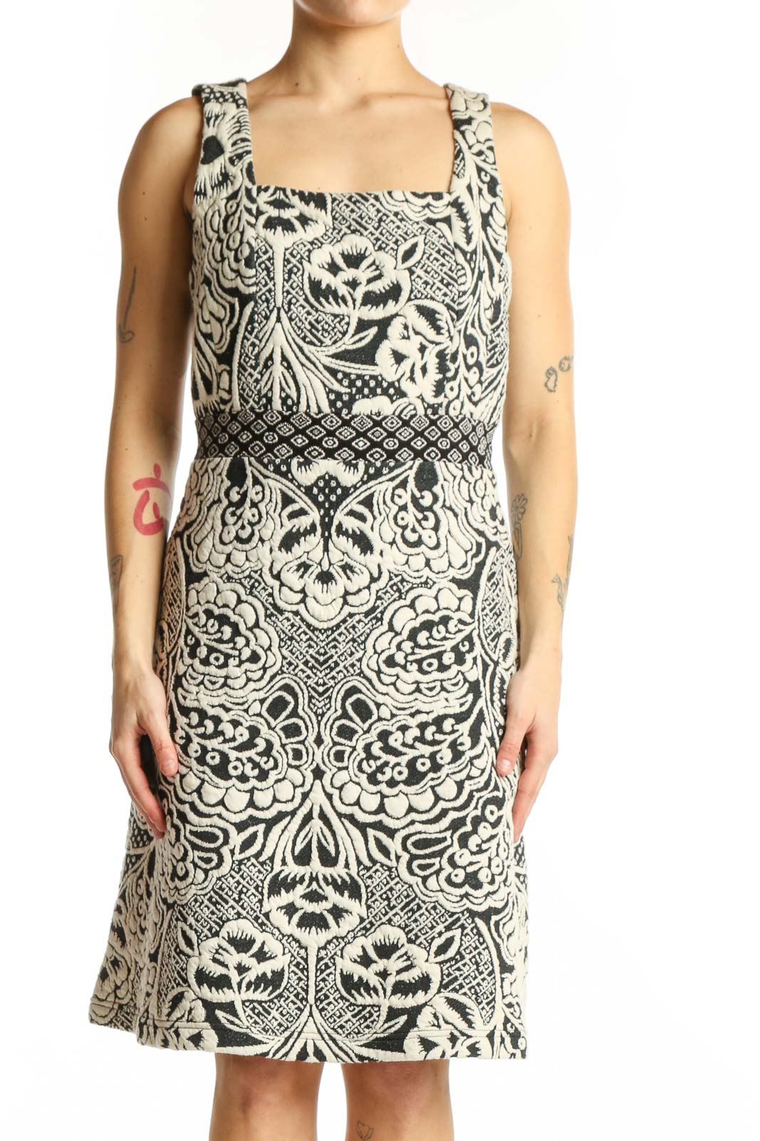 Front view of cream and black ornamental print sleeveless dress with square neckline and A-line silhouette