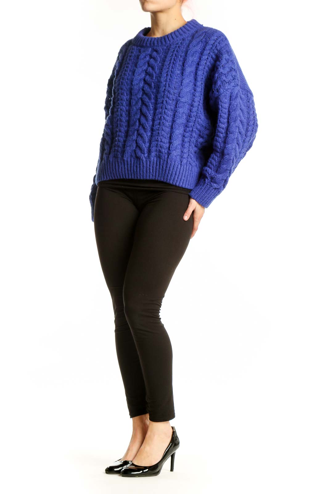 Blue cable knit pullover sweater with crew neckline and cropped length, worn with black pants