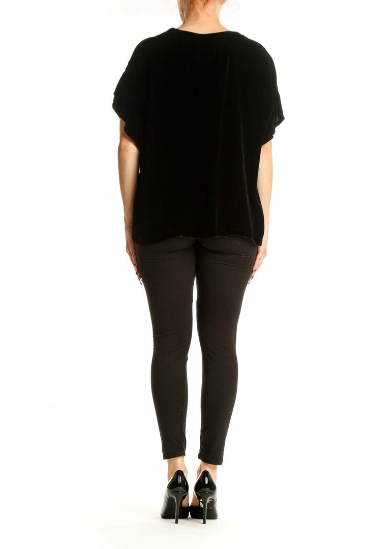 Black velvet short sleeve top with oversized fit, back view