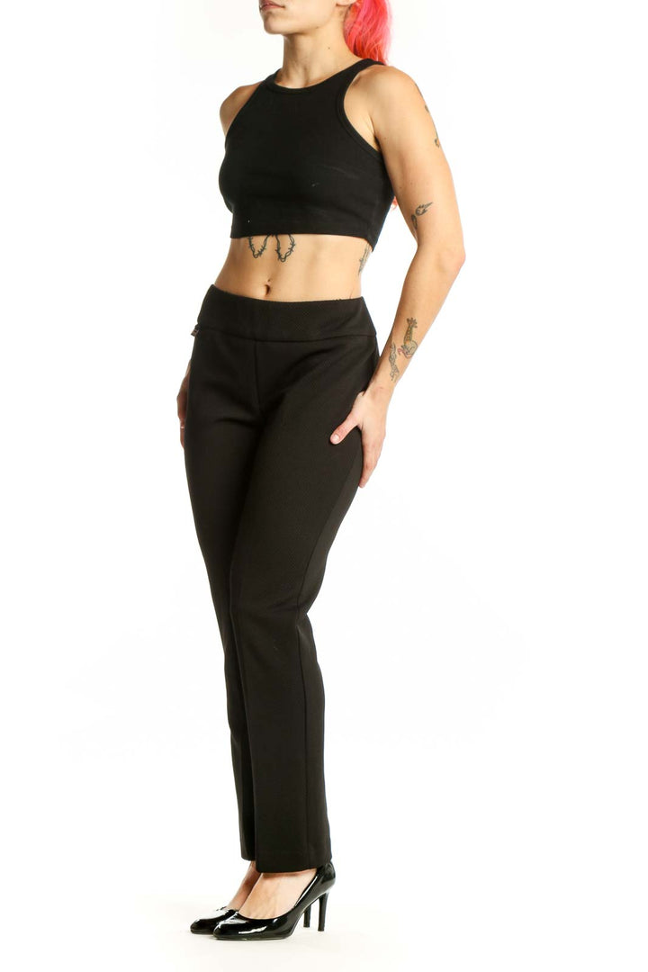 Black stretch dress pants with high-waisted design and straight-leg cut, front view