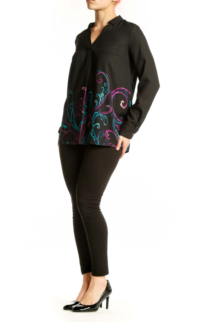 Black Dana Buchman blouse with vibrant teal, magenta, and purple embroidered floral design on front