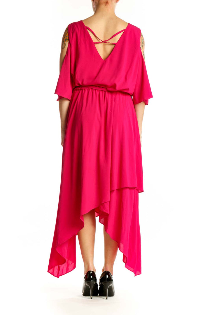 Back view of pink cold shoulder midi dress showing draped sleeves and flowing asymmetrical hem by Lane Bryant