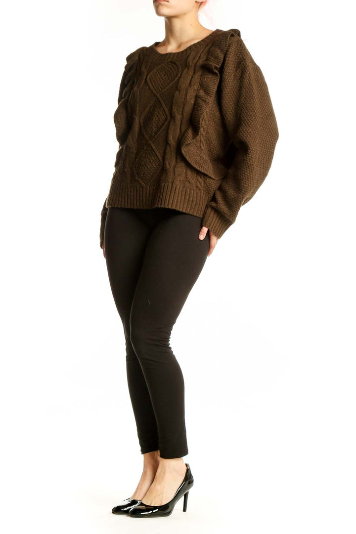 Brown cable knit sweater with ruffle shoulder detail and cable pattern front view