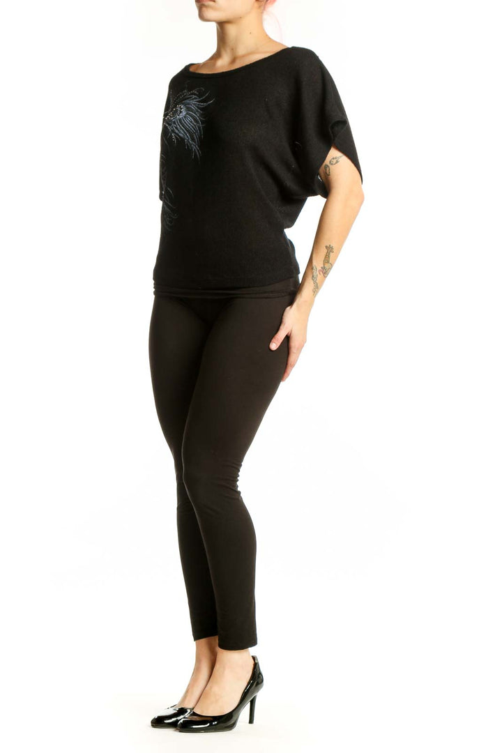 Black embellished top with peacock feather design and shimmering beadwork on front