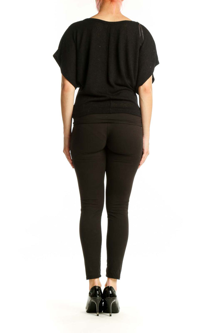 Back view of black embellished top showing peacock feather embroidery detail