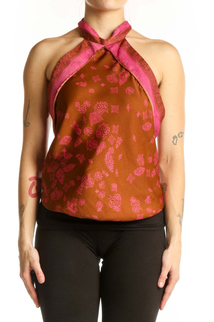 Orange floral halter neck tank top with pink accents and straps, front view on model