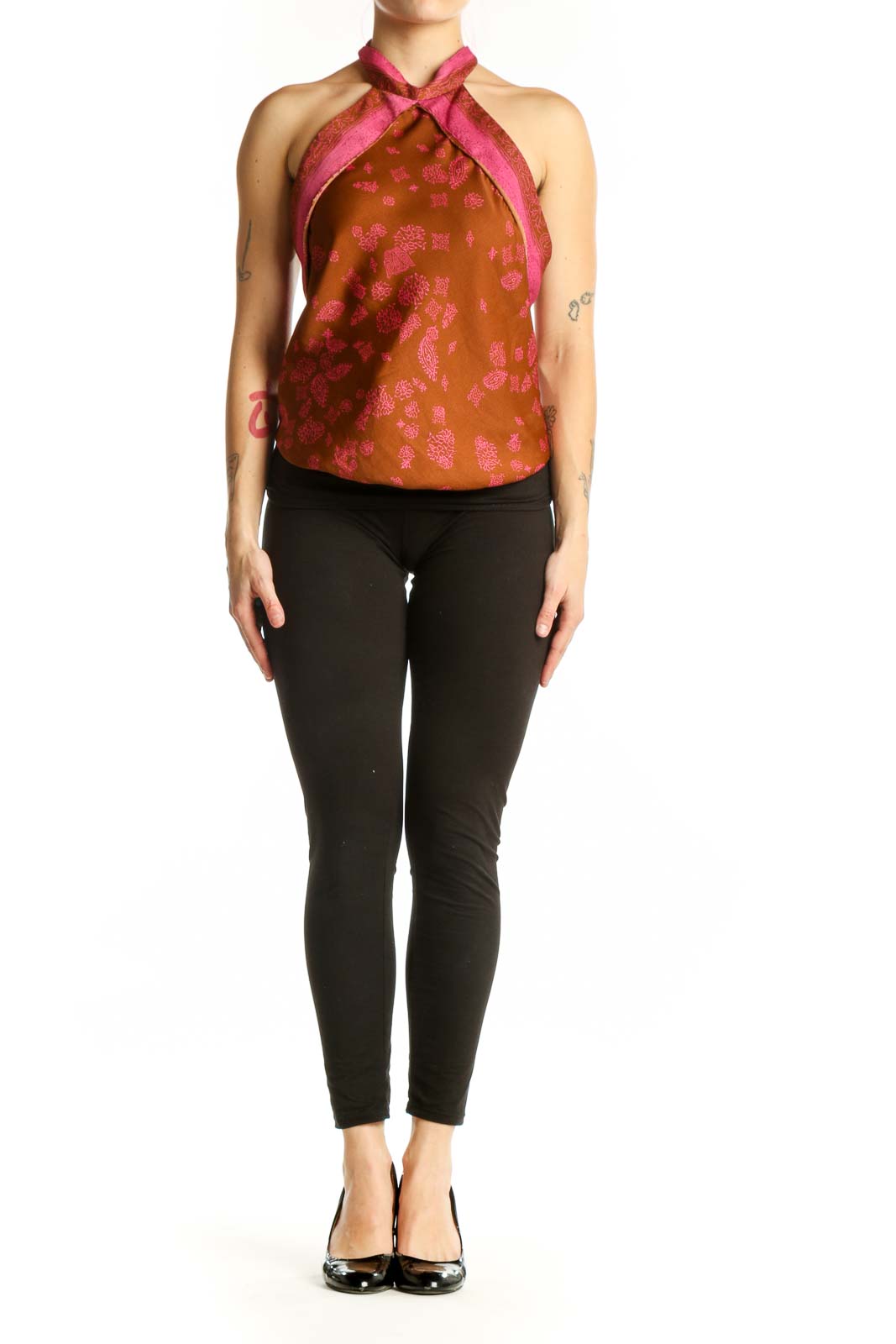 Orange floral halter neck tank top with pink accents and straps, front view on model