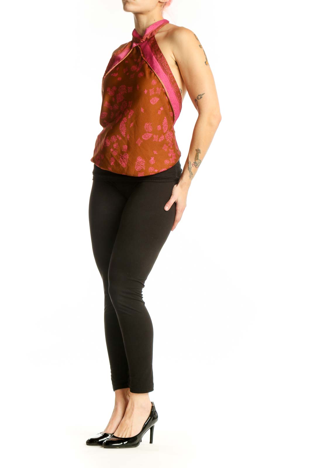 Orange floral halter neck tank top with pink accents and straps, front view on model