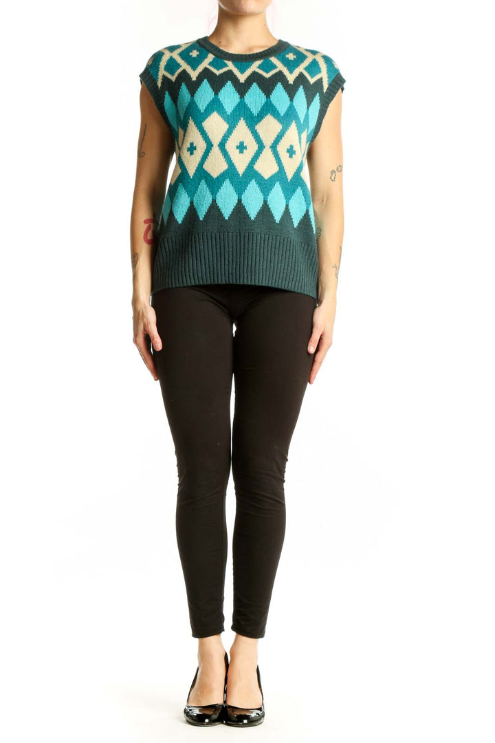 Tyler Boe teal geometric diamond knit vest with cream and charcoal colorblock pattern, front view on model