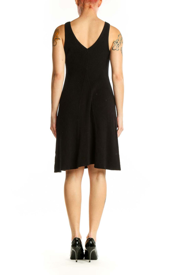 Black ribbed tank dress with A-line silhouette, back view showing sleeveless design
