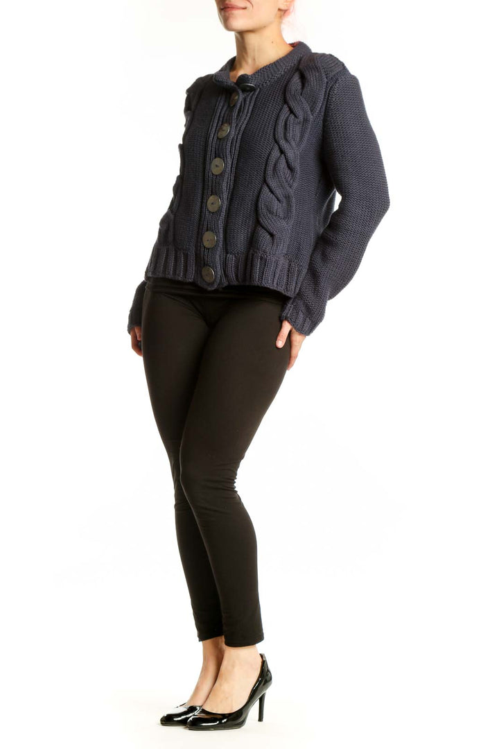 Navy cable knit cotton cardigan with button front closure and decorative cable patterns on sides