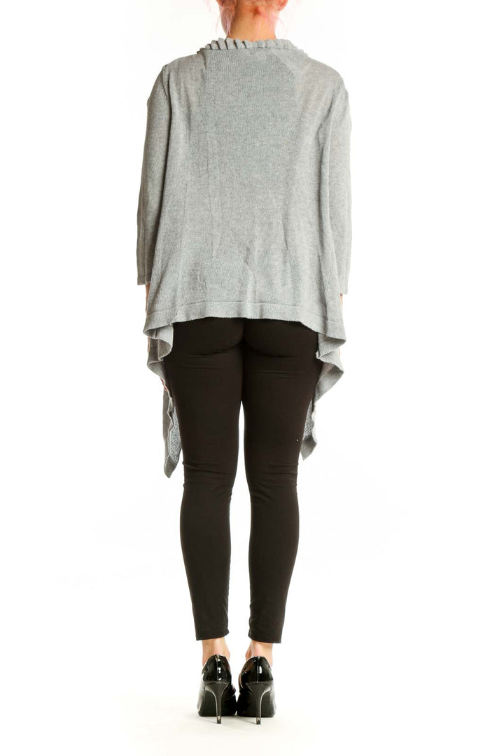 Back view of gray ruffled cotton cardigan showing flowing silhouette and three-quarter length sleeves