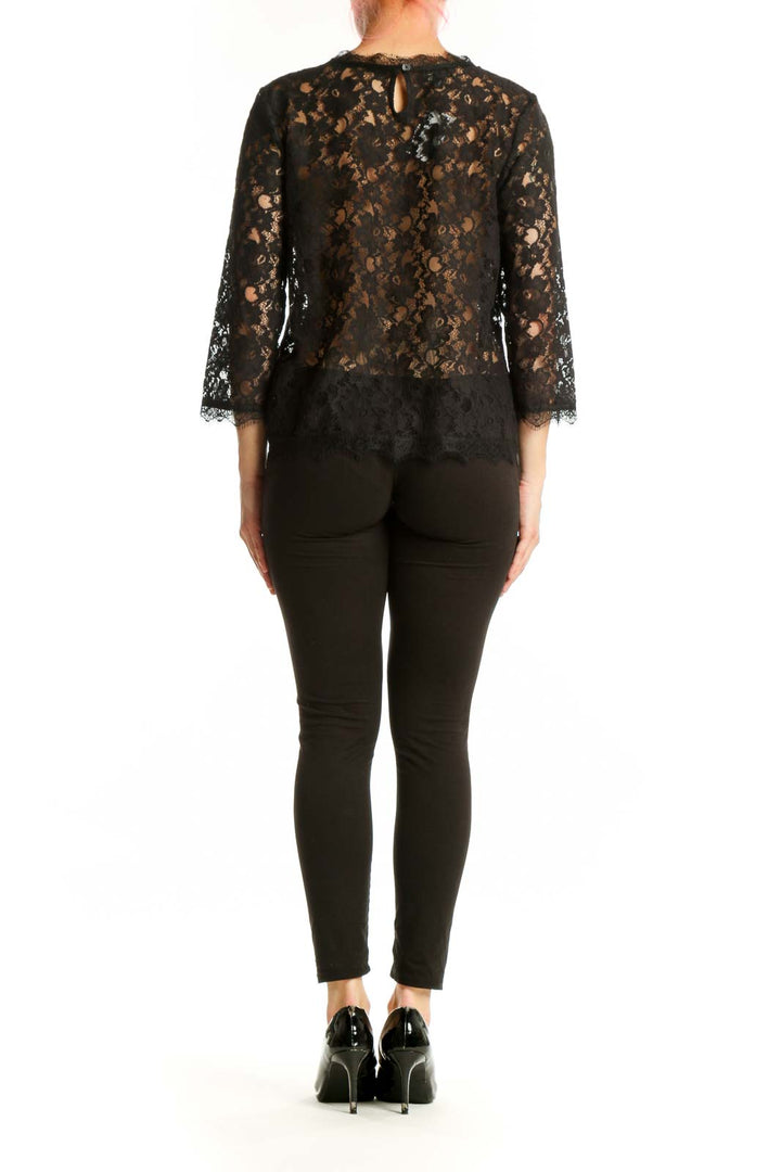 Black lace top with three-quarter sleeves, back view showing elegant lace detailing