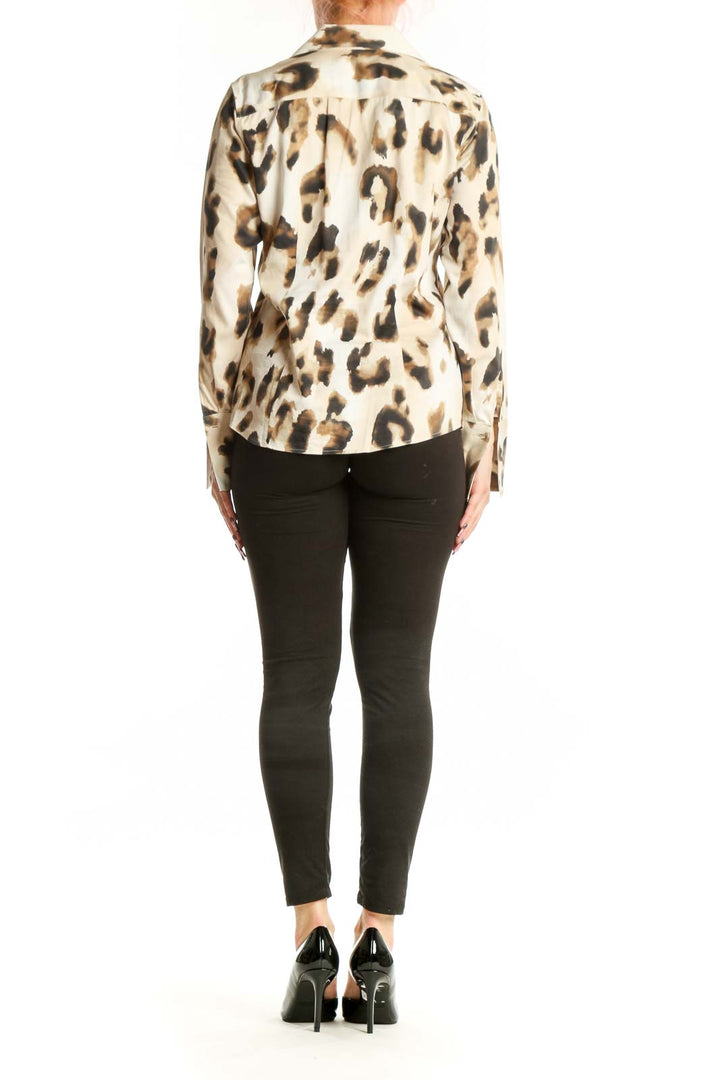 Back view of cream leopard print button-up shirt showing full leopard pattern and fitted silhouette