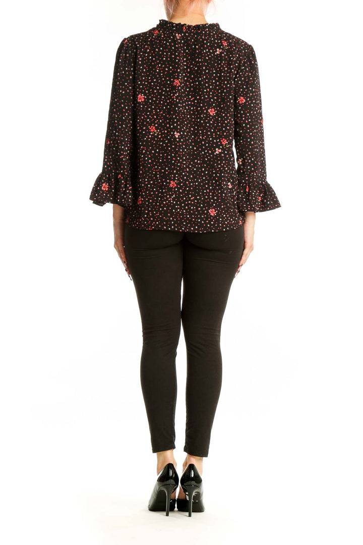 Black floral ruffle sleeve top back view showing full pattern and sleeve detail