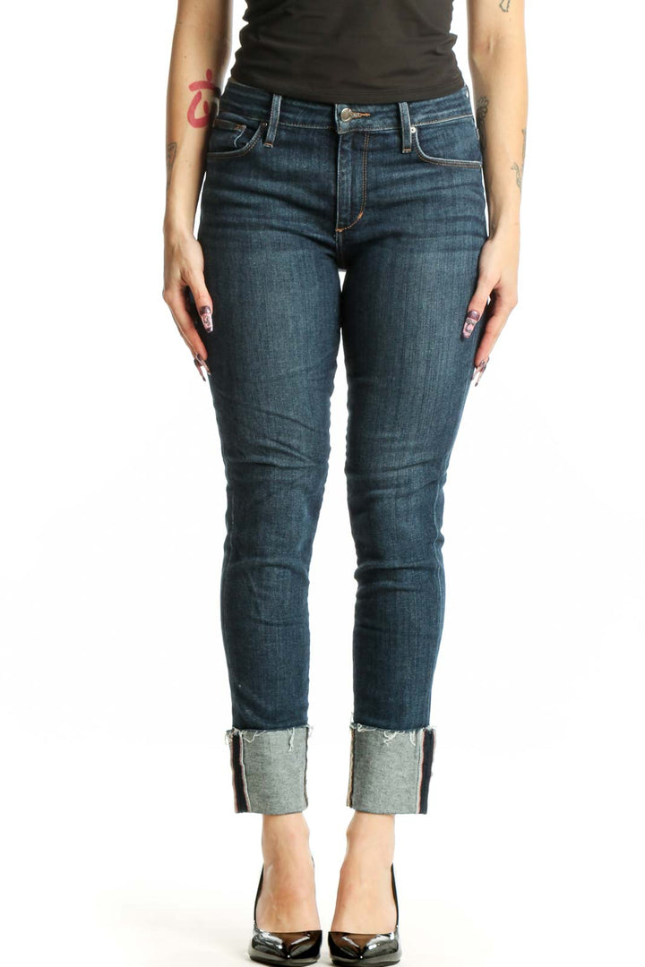 Front view of blue cropped skinny denim jeans with rolled cuffs and mid-rise fit