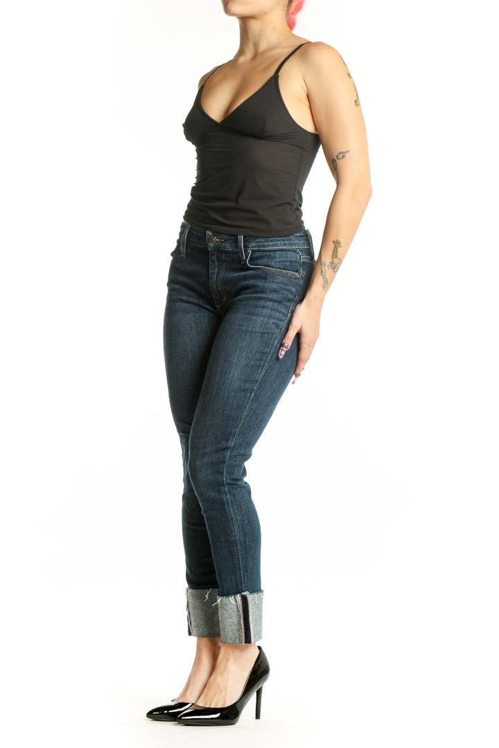 Front view of blue cropped skinny denim jeans with rolled cuffs and mid-rise fit