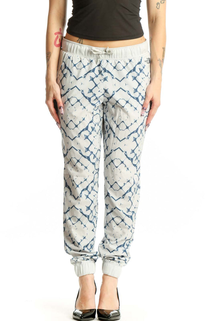Cream and navy geometric print activewear joggers with tapered ankles and drawstring waistband, front view