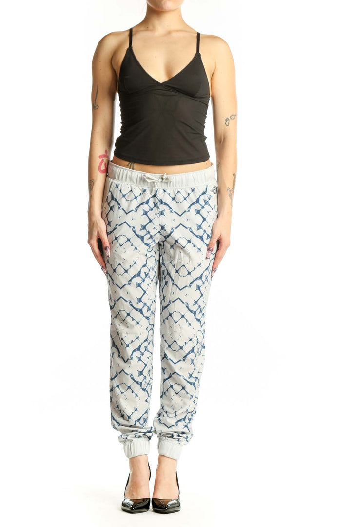Cream and navy geometric print activewear joggers with tapered ankles and drawstring waistband, front view
