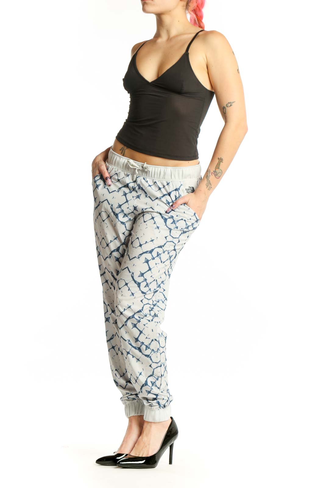 Cream and navy geometric print activewear joggers with tapered ankles and drawstring waistband, front view
