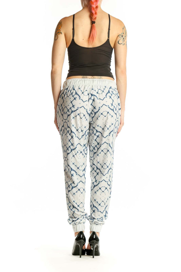 Cream and navy geometric print activewear joggers with tapered ankles, back view showing relaxed fit