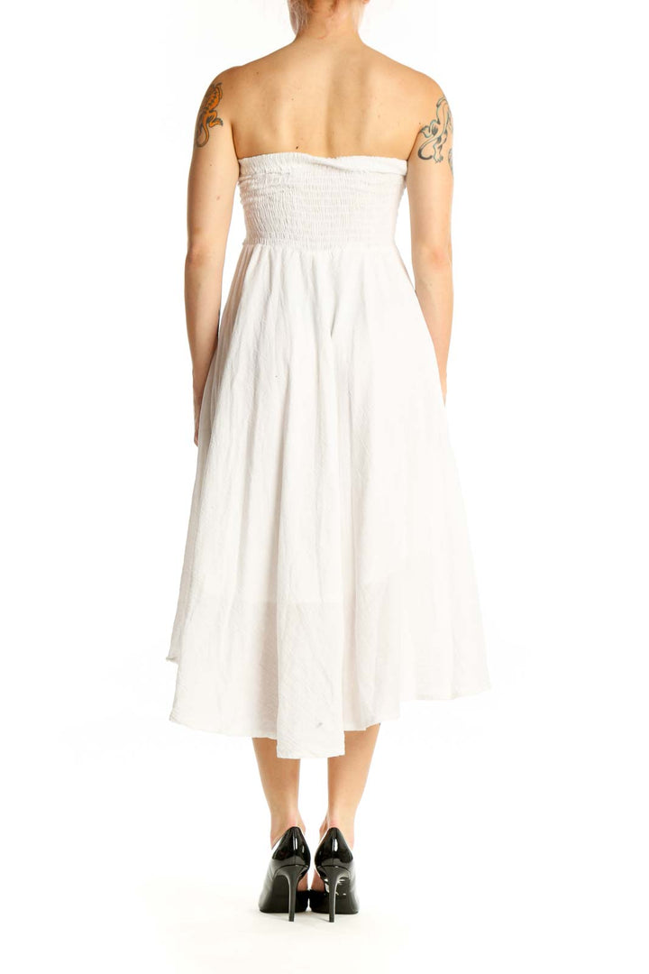 White strapless cotton midi dress with tie-front detail and flowing skirt, back view