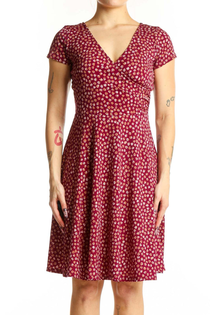 Burgundy floral wrap dress with short sleeves and V-neckline, front view on model