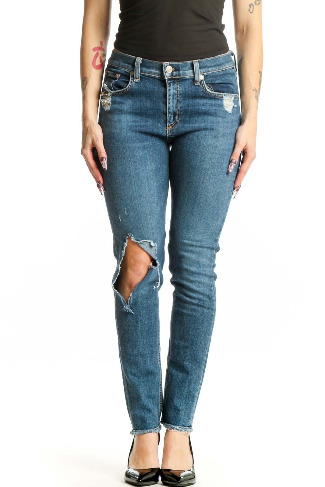 Front view of blue distressed skinny jeans with ripped thigh detailing and cropped ankle length
