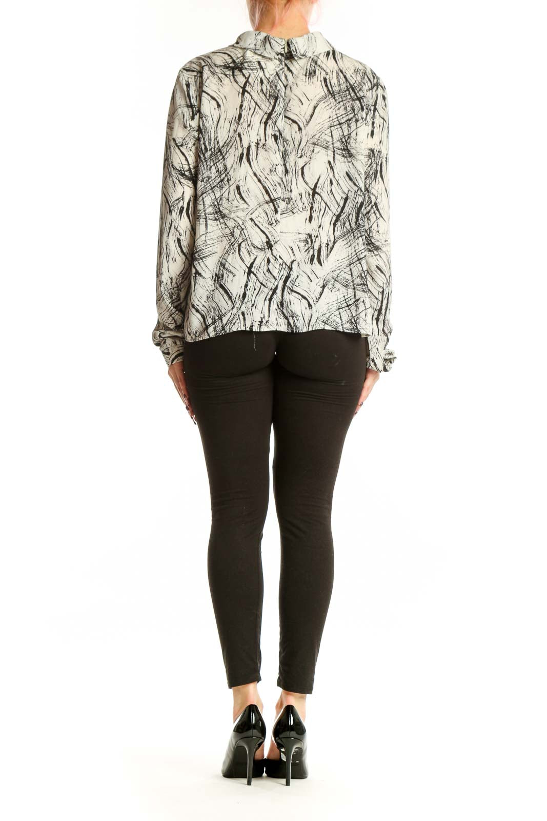 Cream and black abstract print choker blouse with cutout neckline, back view showing flowing silhouette